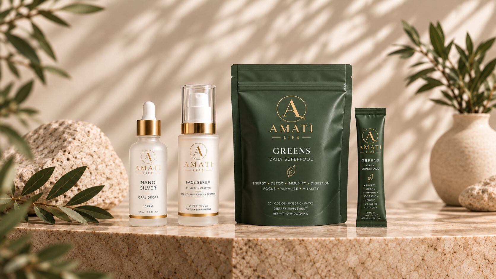 The AMATI collection: Nano Silver oral drops, Face Serum, the Greens pouch and a Greens stick pack on a marble ledge